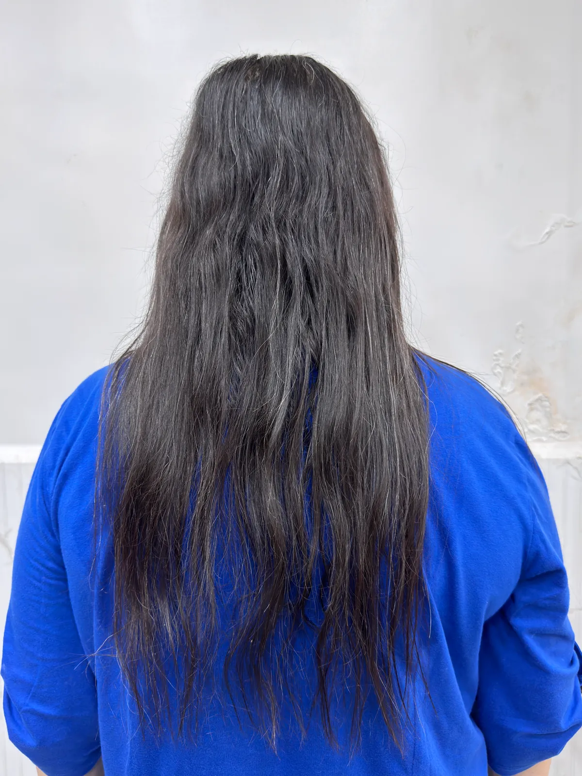 Real client wavy coarse hair before smoothing treatment